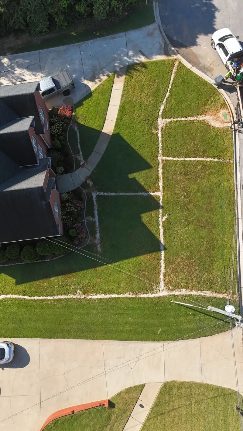 Sprinkler spraying a residential lawn on a sunny day in Trussville, AL