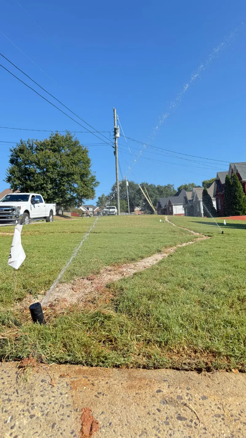 Irrigation system watering a maintained lawn and landscape beds in the Trussville area